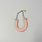 Ceramic Horseshoe Wall Hanging. Made from ceramic, this one of a kind piece adds a touch of rustic charm to any room. Enhance your space with this hand-crafted horseshoe, a symbol of good luck and protection.