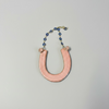 Ceramic Horseshoe Wall Hanging. Made from ceramic, this one of a kind piece adds a touch of rustic charm to any room. Enhance your space with this hand-crafted horseshoe, a symbol of good luck and protection.