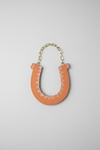 Ceramic Horseshoe Wall Hanging. Made from ceramic, this one of a kind piece adds a touch of rustic charm to any room. Enhance your space with this hand-crafted horseshoe, a symbol of good luck and protection.